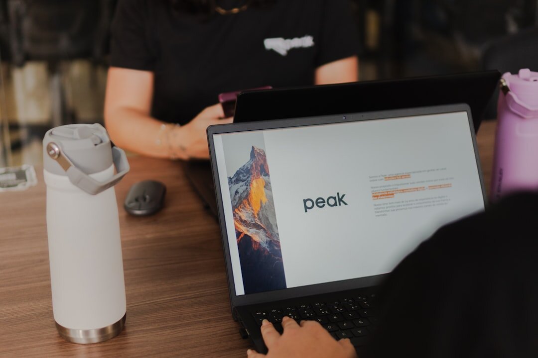 Startup team collaborating around a table with laptops